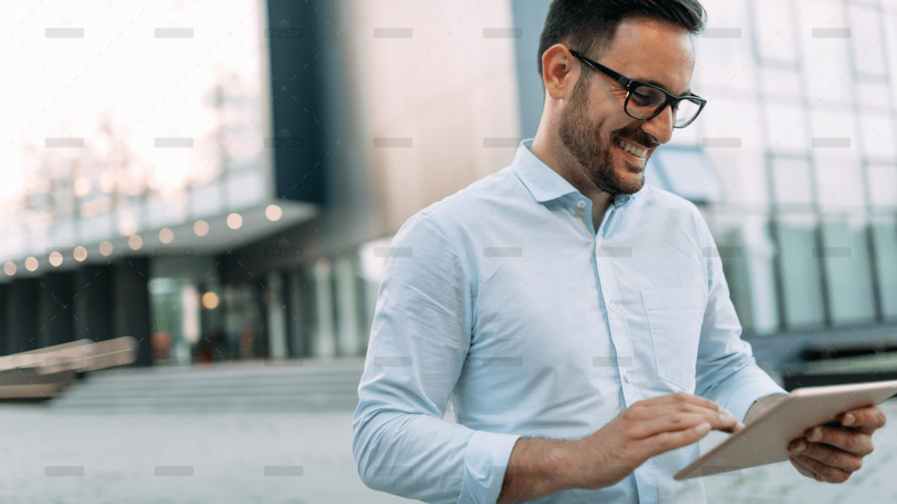 demo-attachment-1706-portrait-of-businessman-in-glasses-holding-tablet-AWVHCJU